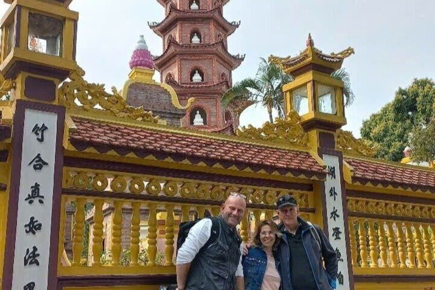 A traditional Chinese gate with intricate designs and a pagoda in the background. 5