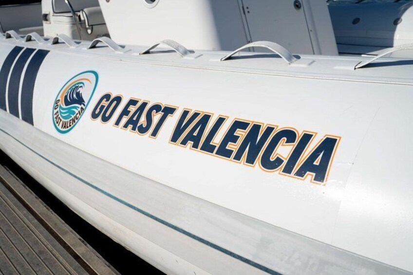 A boat with 'GO FAST VALENCIA' and a logo on its side. 2
