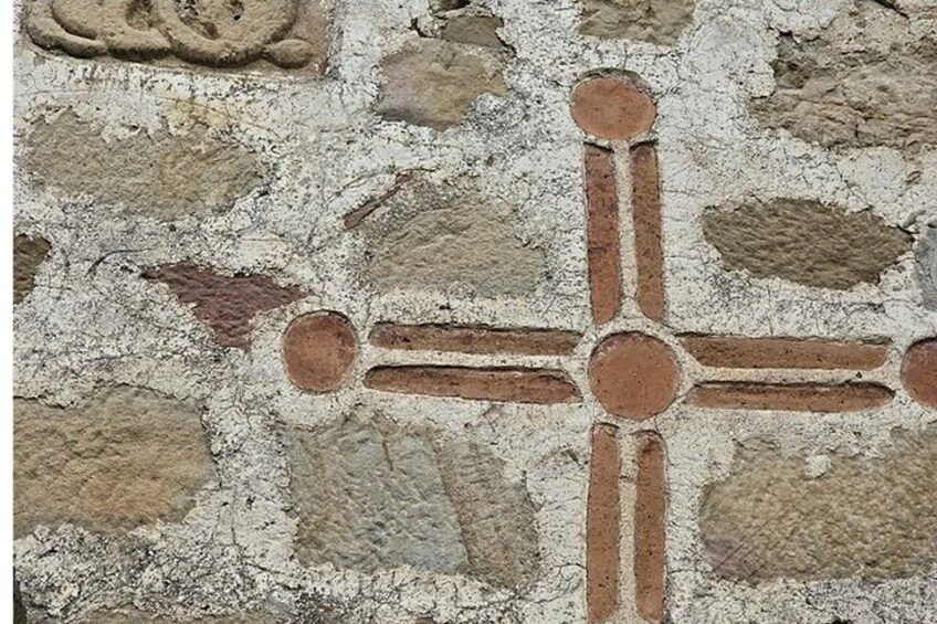 A mosaic with geometric patterns and circular designs. 5