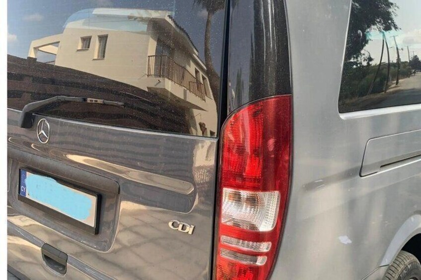 A vehicle with a visible license plate, rear lights, and a Mercedes-Benz emblem. 4