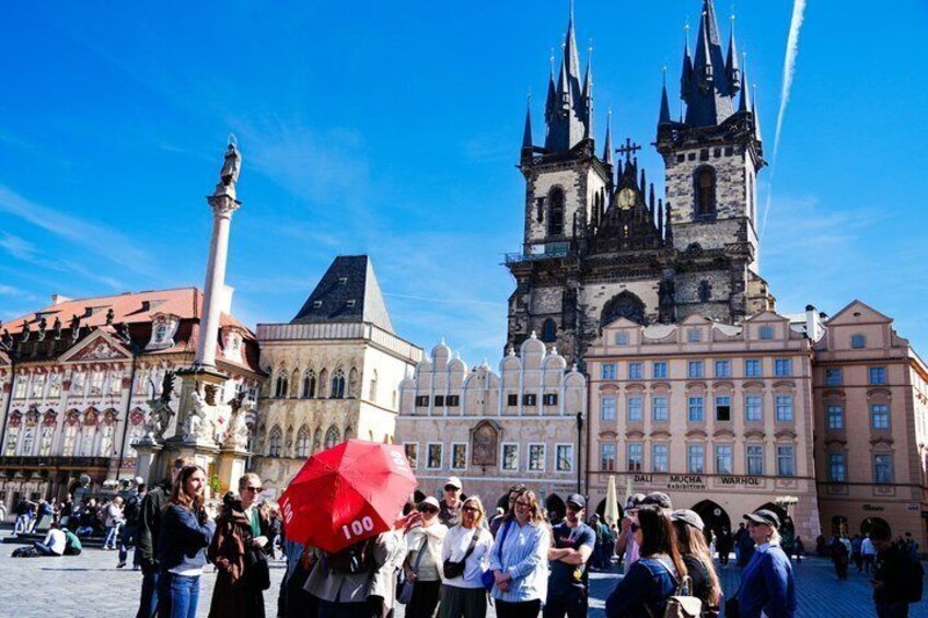 A historic square with a prominent church and a statue. 2