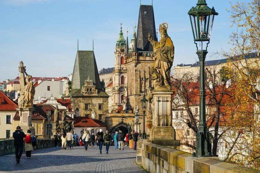 A historic square with statues, a prominent church, and cobblestone streets. 3