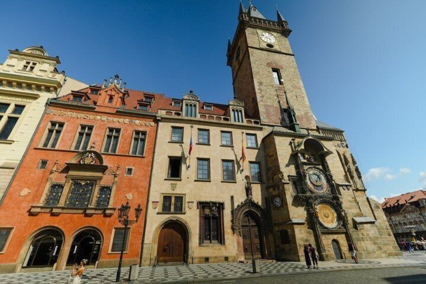 A historic building with a clock tower, arched windows, and a prominent entrance. 5