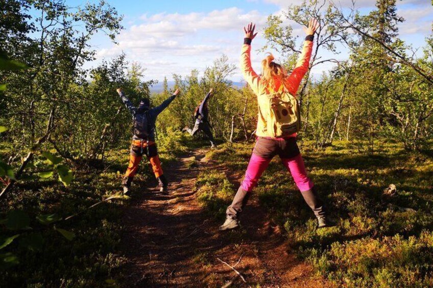 Two people hiking on a forest trail. 1