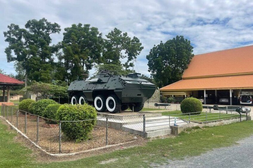 A military tank on display with a building in the background. 4