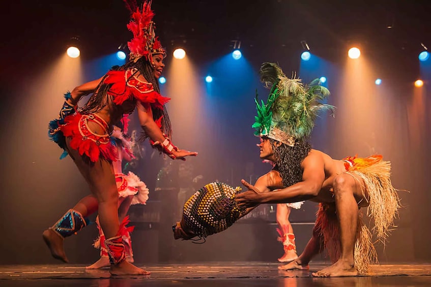Performers in traditional costumes on stage with spotlights. 2