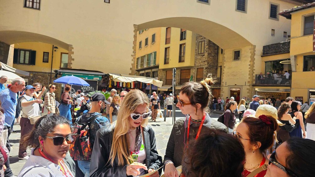 A crowded outdoor market with people shopping and interacting. 5