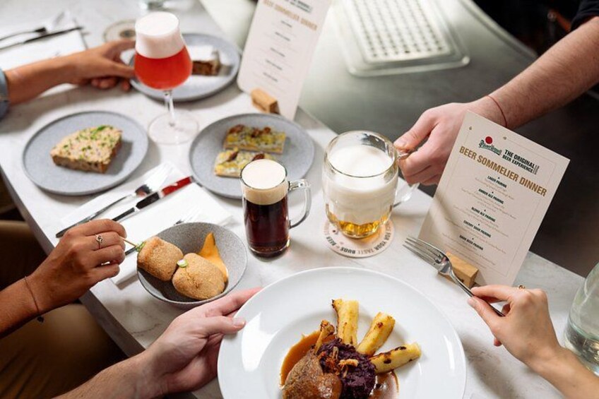 A dining table with various dishes, drinks, and a menu. 2