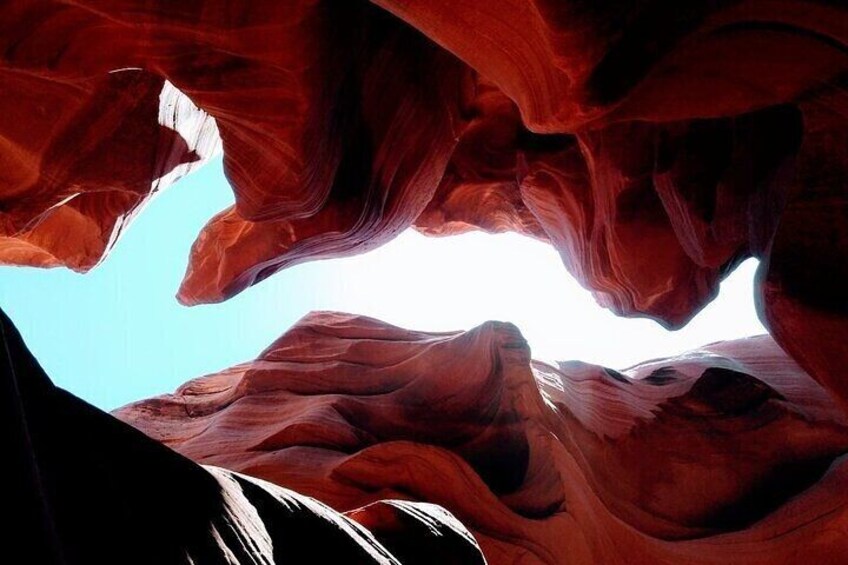 A canyon with red rock formations and a clear sky. 3