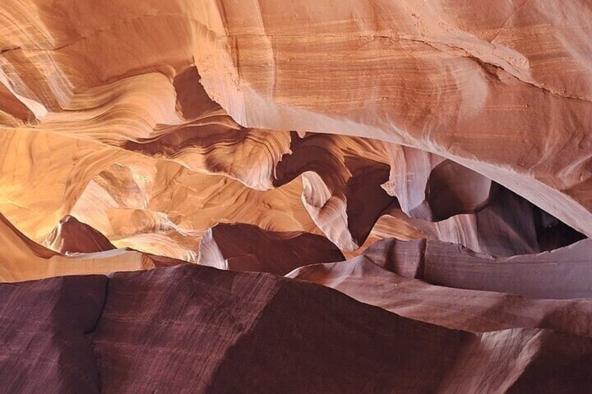 A close-up of layered sandstone with striations and erosion patterns. 4