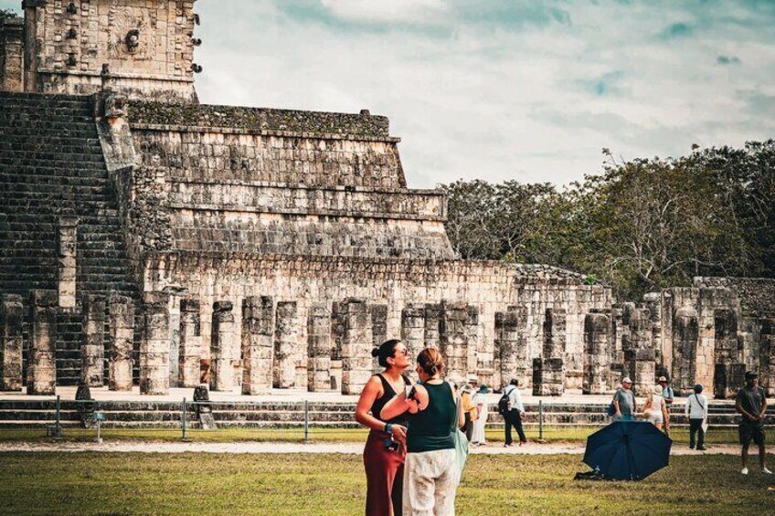 A couple embracing in front of an ancient stone structure. 3