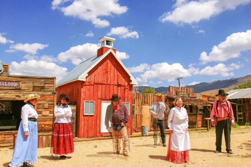A red wooden building with a bell tower, a sign reading 'Jail,' and a sign for 'Sheriff.' 4