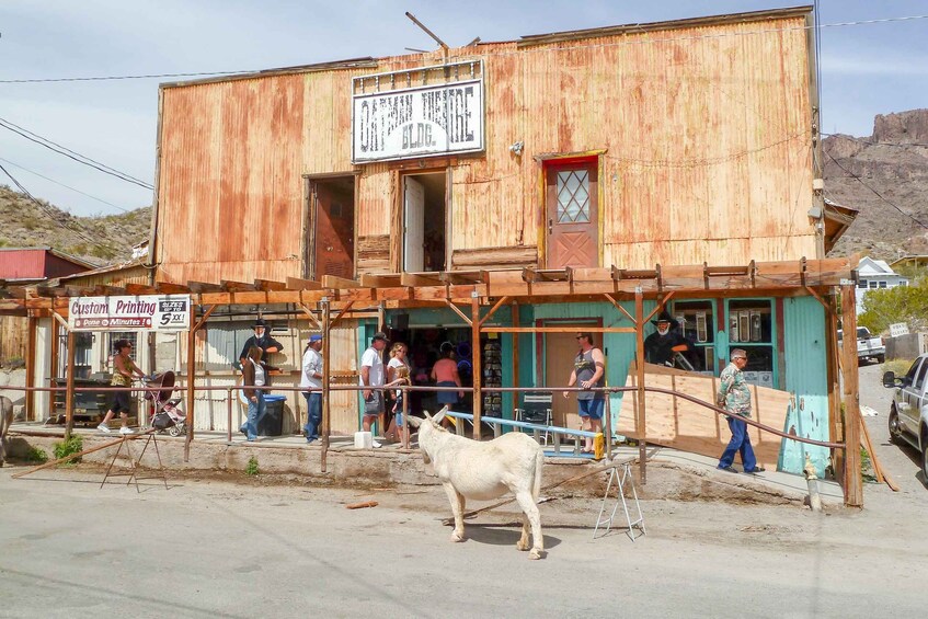 A rustic wooden building with a sign reading 'Custom Printing.' 2