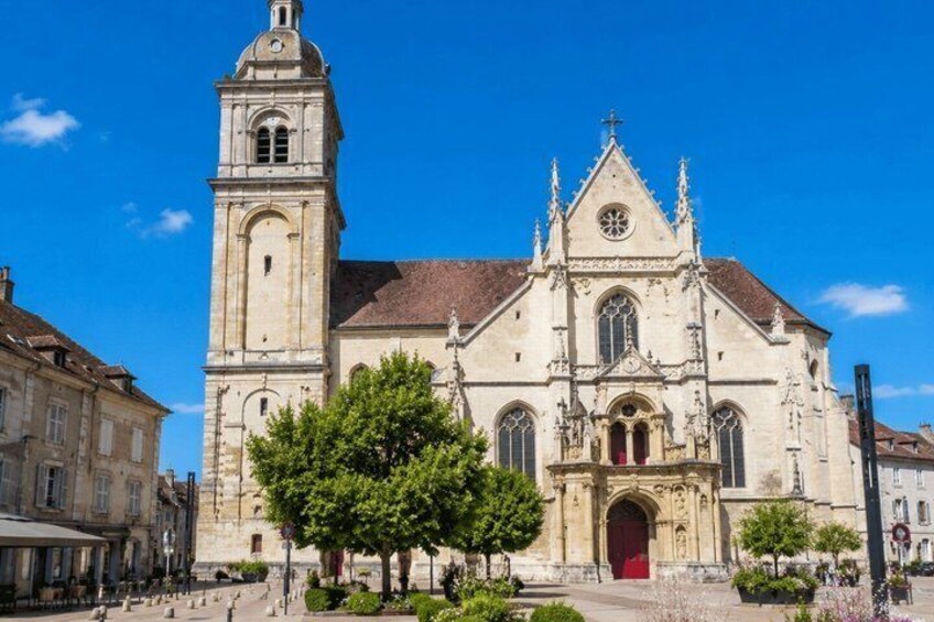 A historic church with a prominent bell tower and a red door. 5