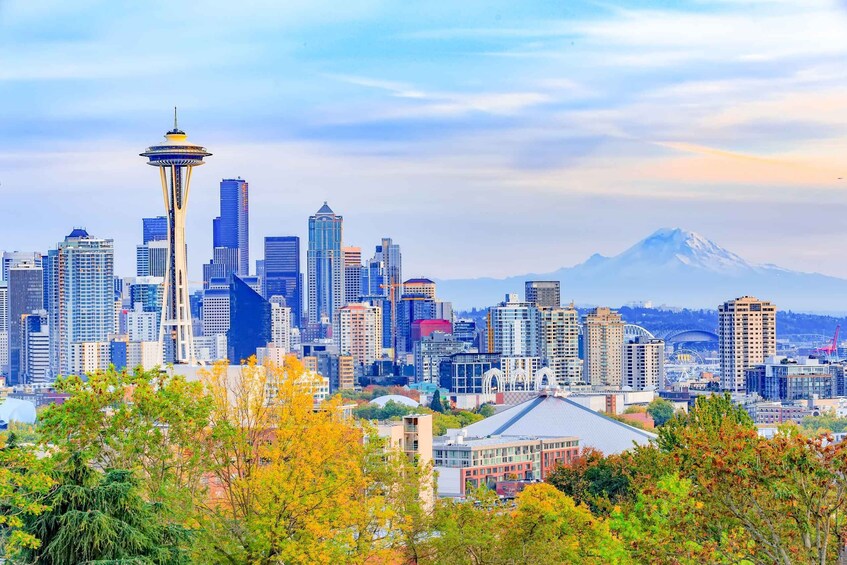 A city skyline with the Space Needle, modern buildings, and a mountain in the background. 4