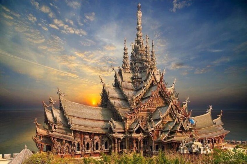 A traditional multi-tiered temple with ornate architecture, a clear sky, and a sunset in the background. 1