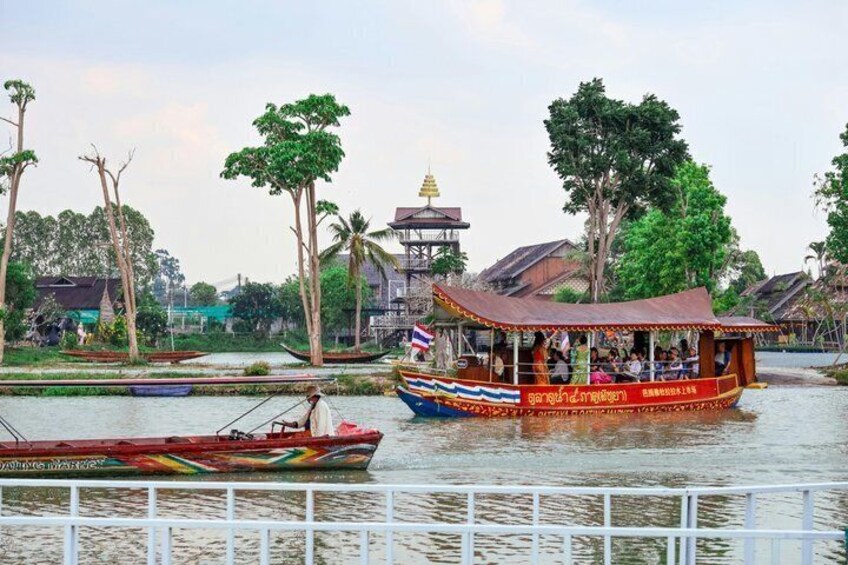 A river with boats, trees, and a temple in the background. 3