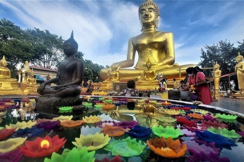A large golden Buddha statue, a smaller seated Buddha, and a lotus pond with colorful lotus flowers. 5