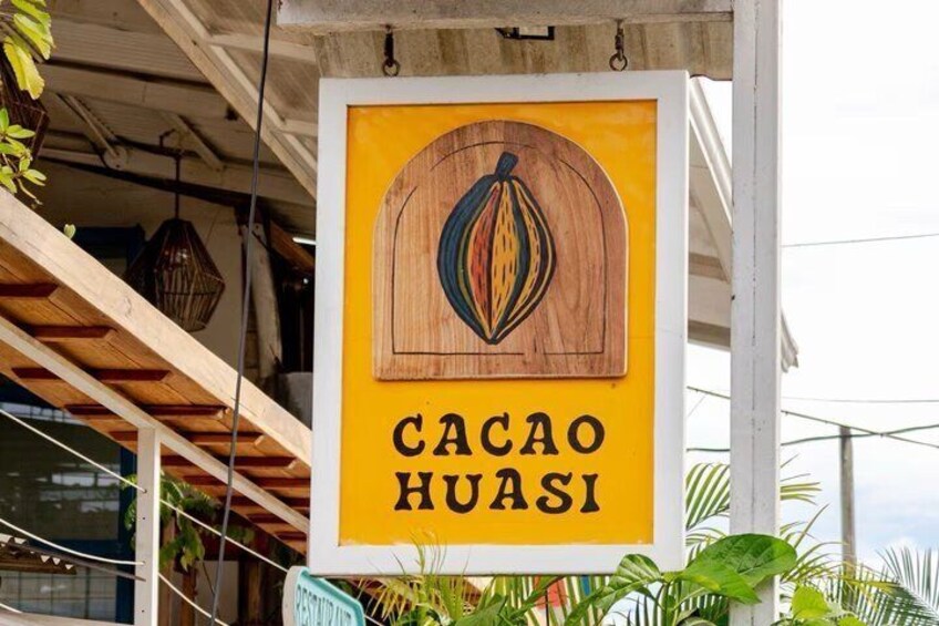 A sign with 'CACAO HUASI' written on it. 3