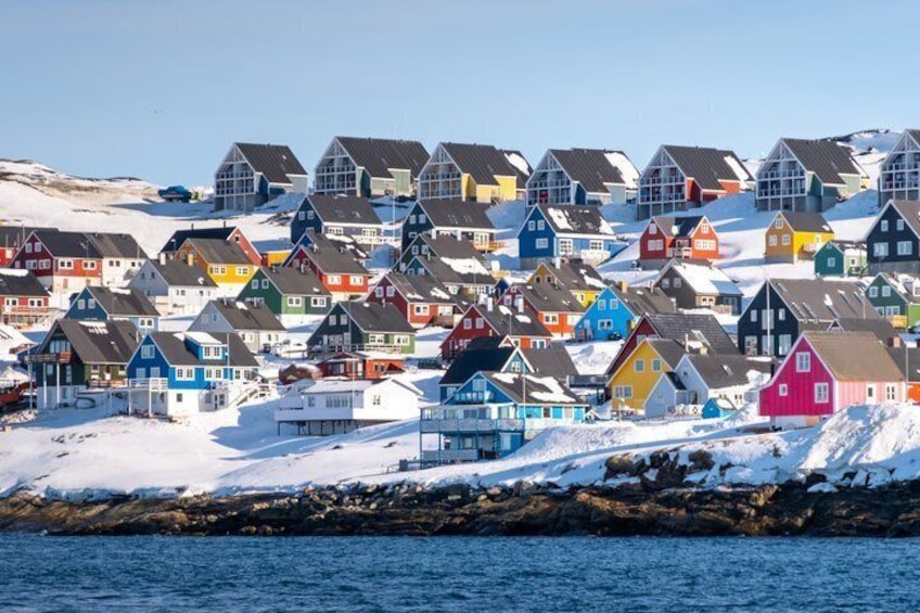A coastal village with colorful houses and snow-covered ground. 5