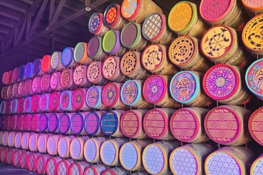 A wall of colorful, patterned mats. 1