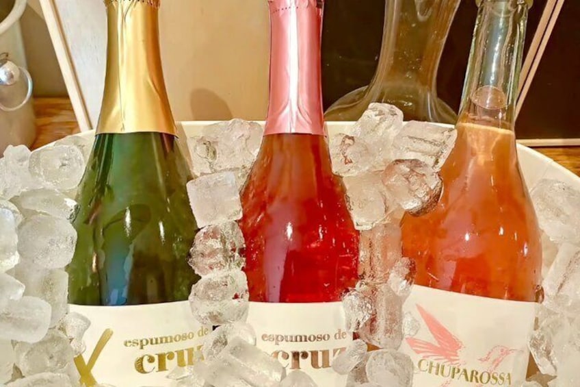 Three bottles of wine on ice with labels. 1