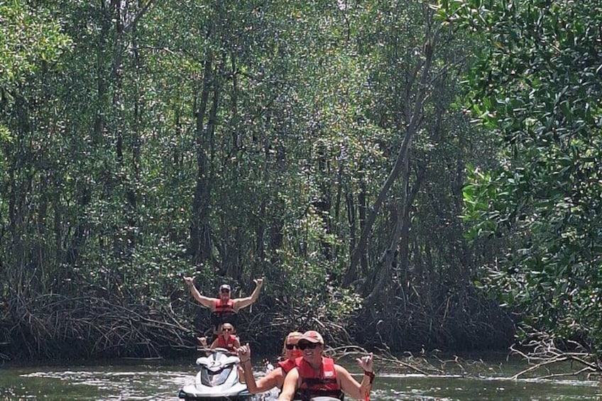 A group of people on a boat in a mangrove area. 4