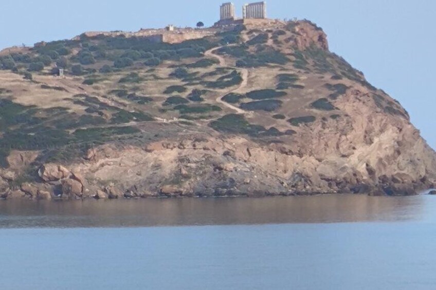 A rocky hill with a clear path leading to a structure on top. 2