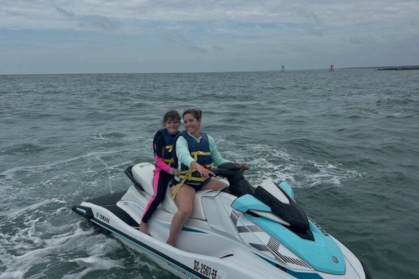 Two people on a jet ski in the water. 3