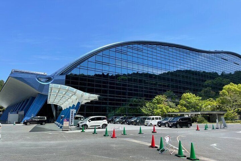 A modern building with a curved glass facade and a unique blue and white entrance. 4