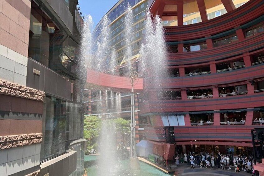 A multi-level building with a water feature in the center. 5