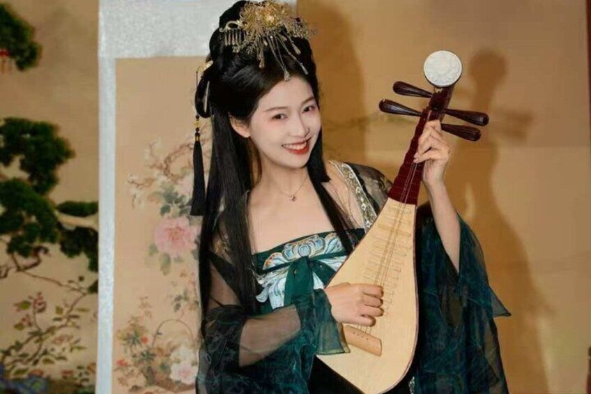 A person holding a traditional stringed instrument. 2