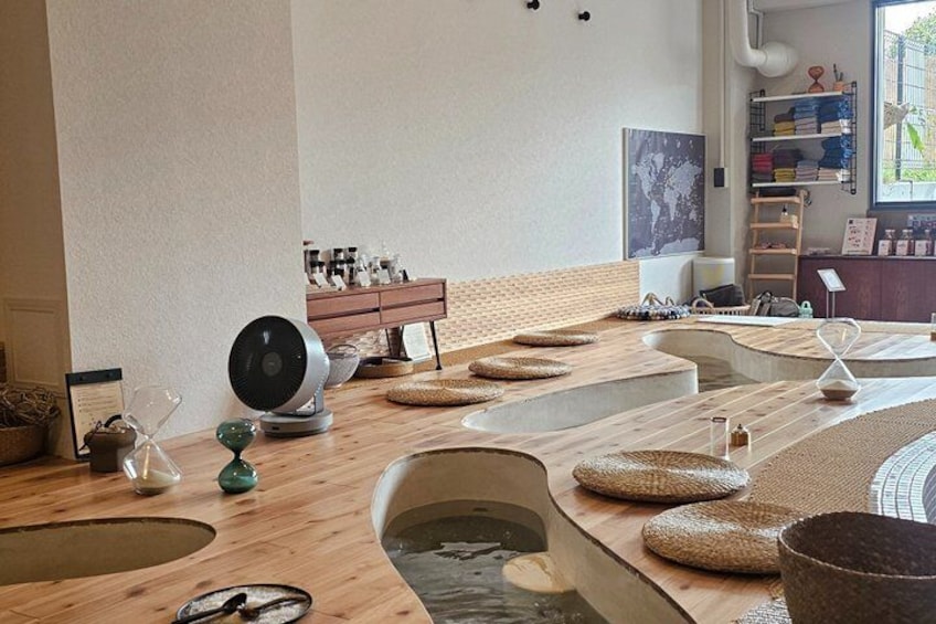 A spa with wooden tubs and a fan. 4