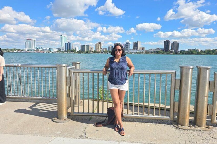 A person standing by a waterfront with a city skyline in the background. 2