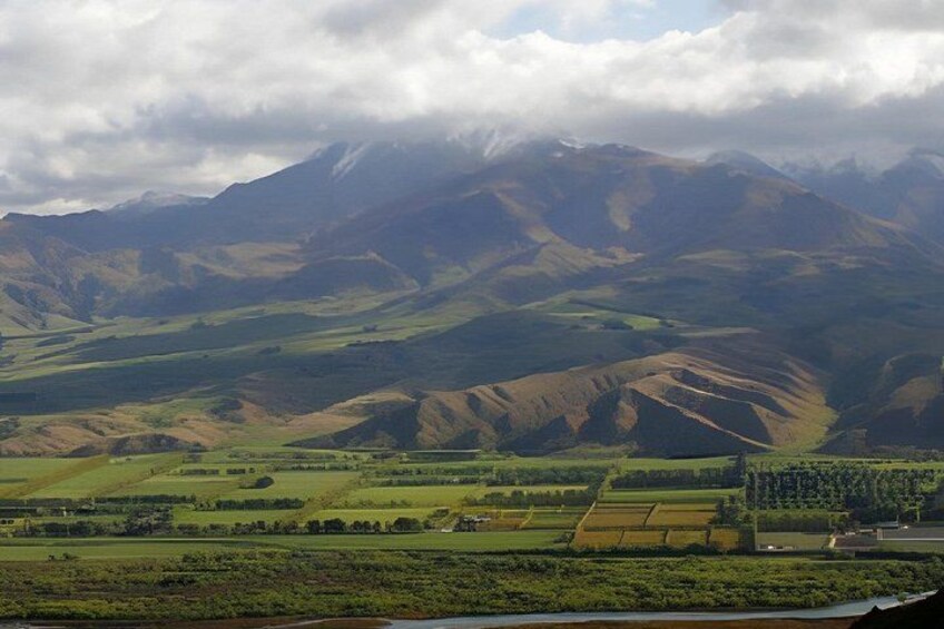 Rolling hills, a river, and distant mountains. 4