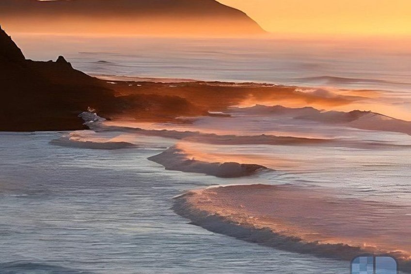A coastal landscape with waves, a cliff, and a sunset. 5
