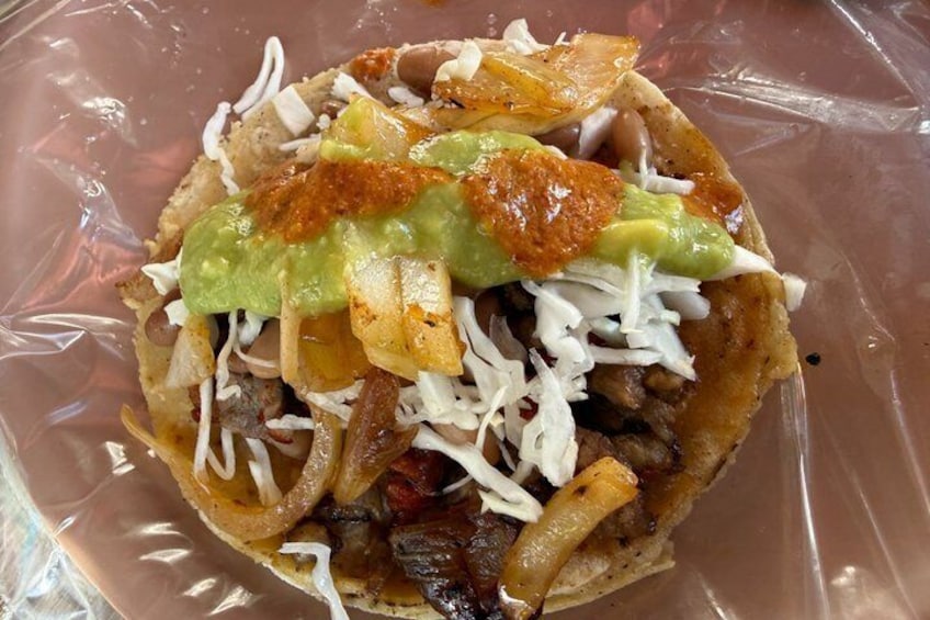 A nacho dish with cheese, beans, and jalapeƱos. 2