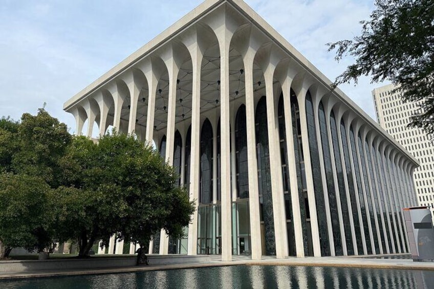 A modern building with a series of vertical columns and large windows. 3