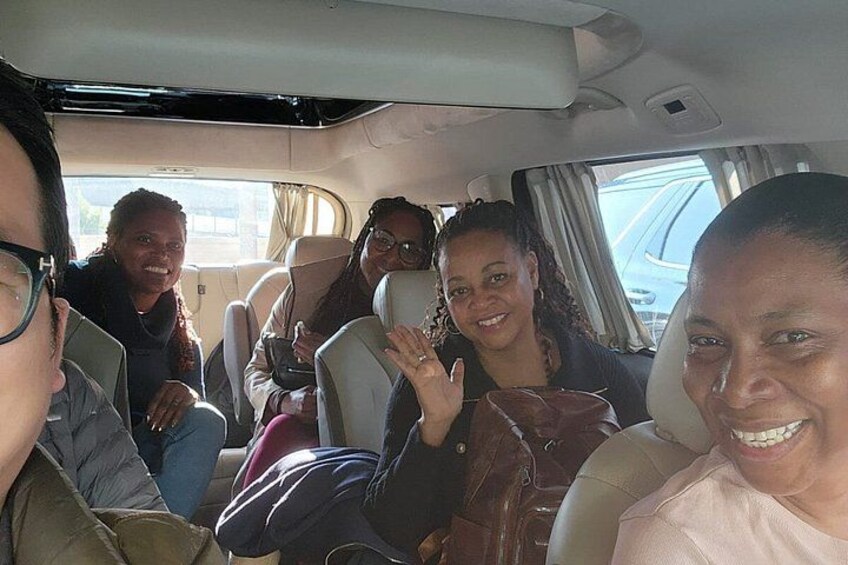 A group of people seated inside a vehicle. 2