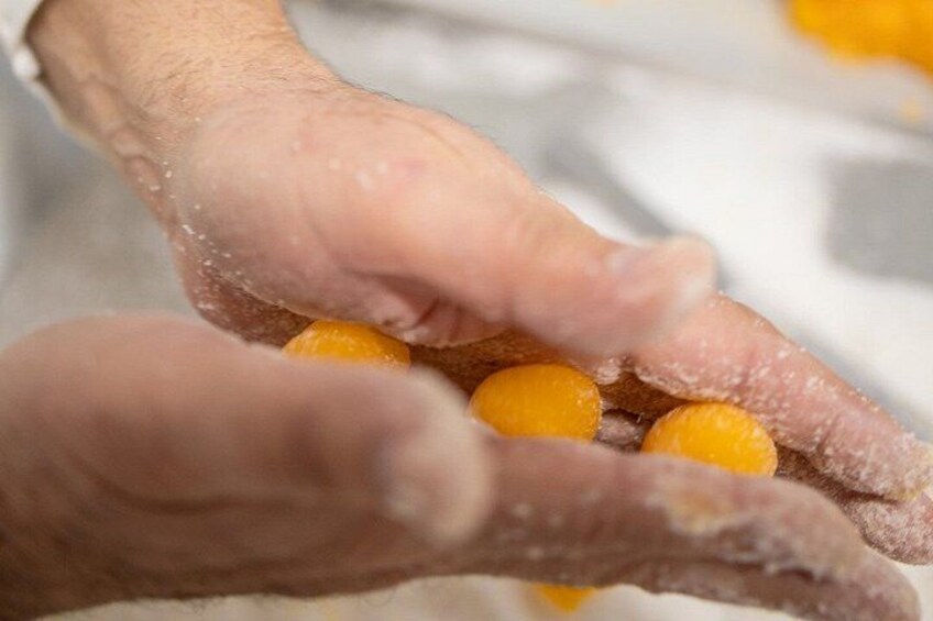 Hands holding and dusting sugar-coated sweets. 1