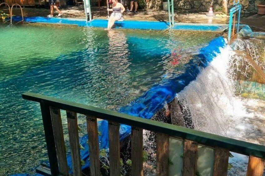A water slide with a wooden railing in the foreground. 4