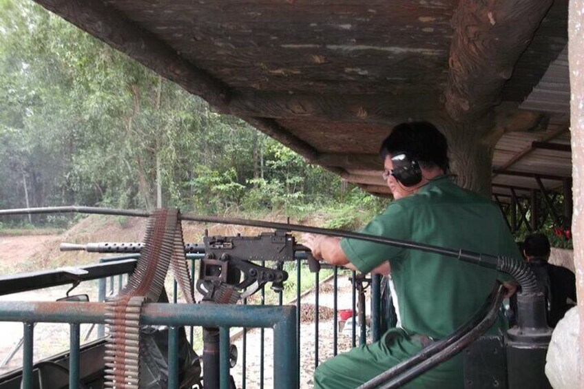 A person aiming a rifle at a target in an outdoor shooting range. 5
