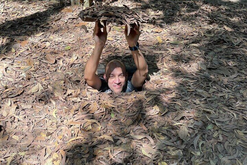 A person lying on the ground surrounded by dry leaves. 2