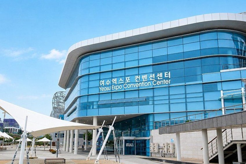 The Yeosu Expo Convention Center with a modern glass facade and a curved design. 3