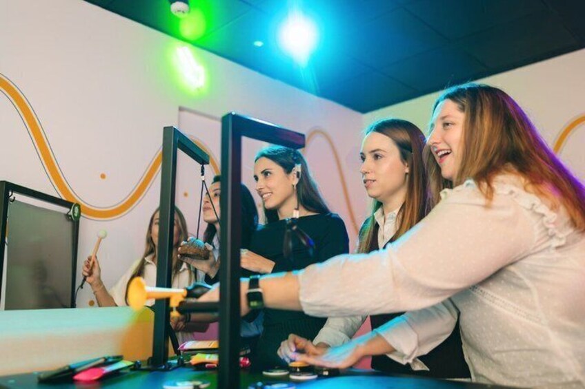 A group of people engaged in a VR gaming session with a VR headset and controllers. 3