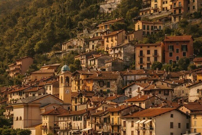 A hillside town with historic buildings and a prominent clock tower. 4