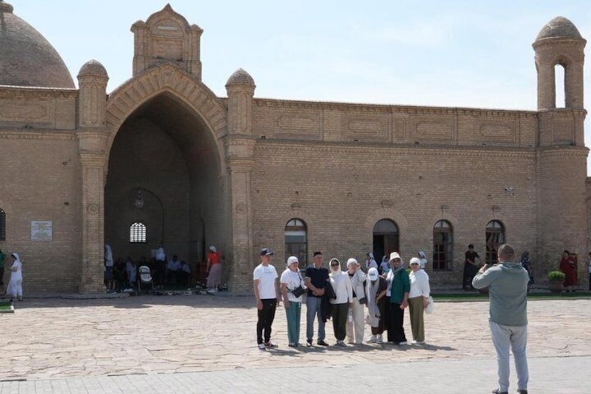 A historic building with arched entrances and domed structures. 3