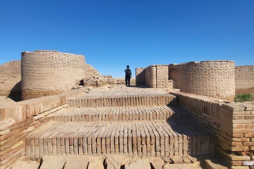 Ancient brick structures with a person standing in the center. 5