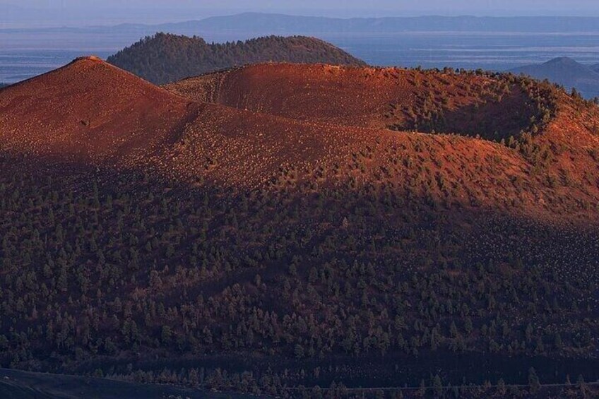 A mountainous landscape with dense forests and rolling hills. 5