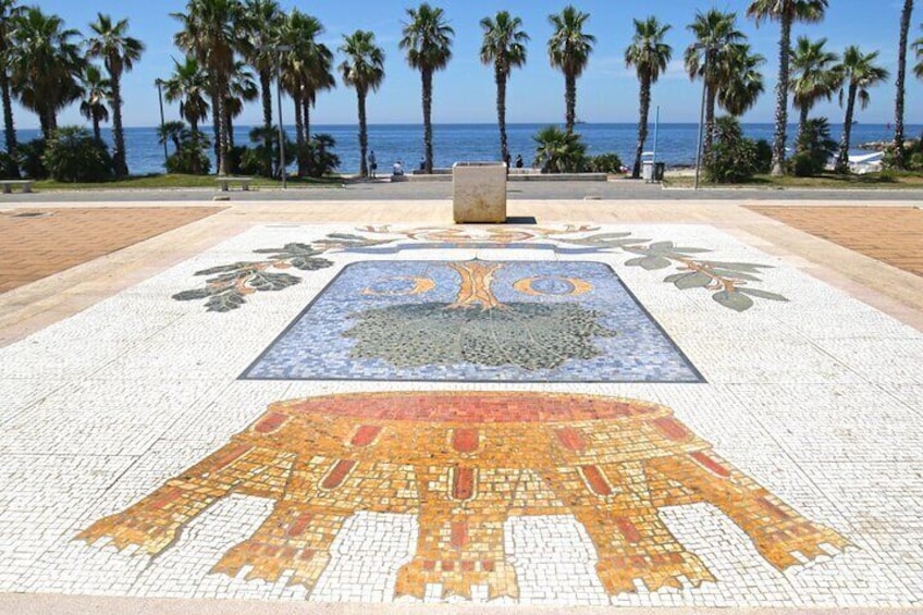 A mosaic with palm trees and a sea view. 4